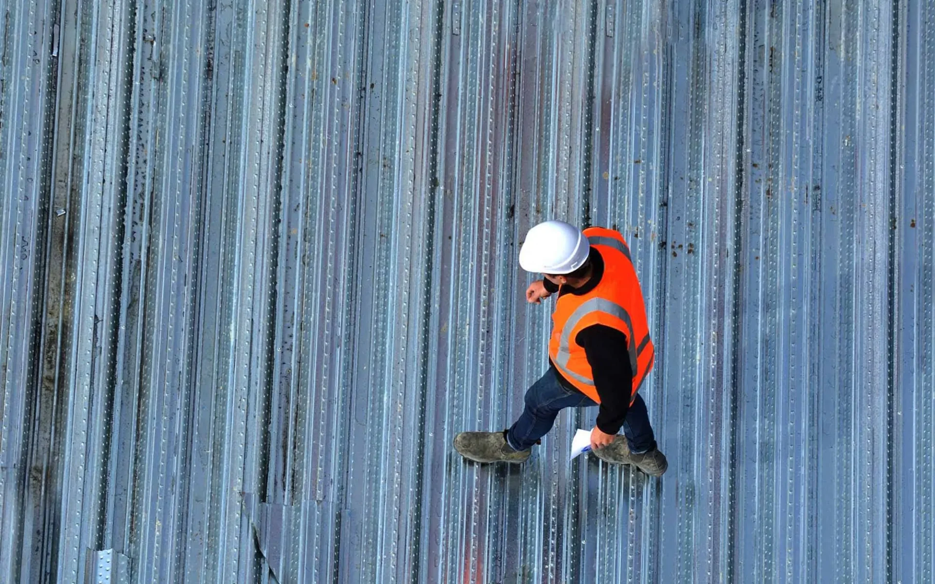 Overhead view of roof inspector on commercial roof